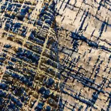 Tissu brodé bleu et doré avec motifs géométriques.