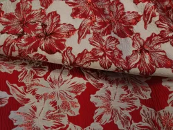 Tissu fleuri rouge et blanc avec motifs hibiscus.